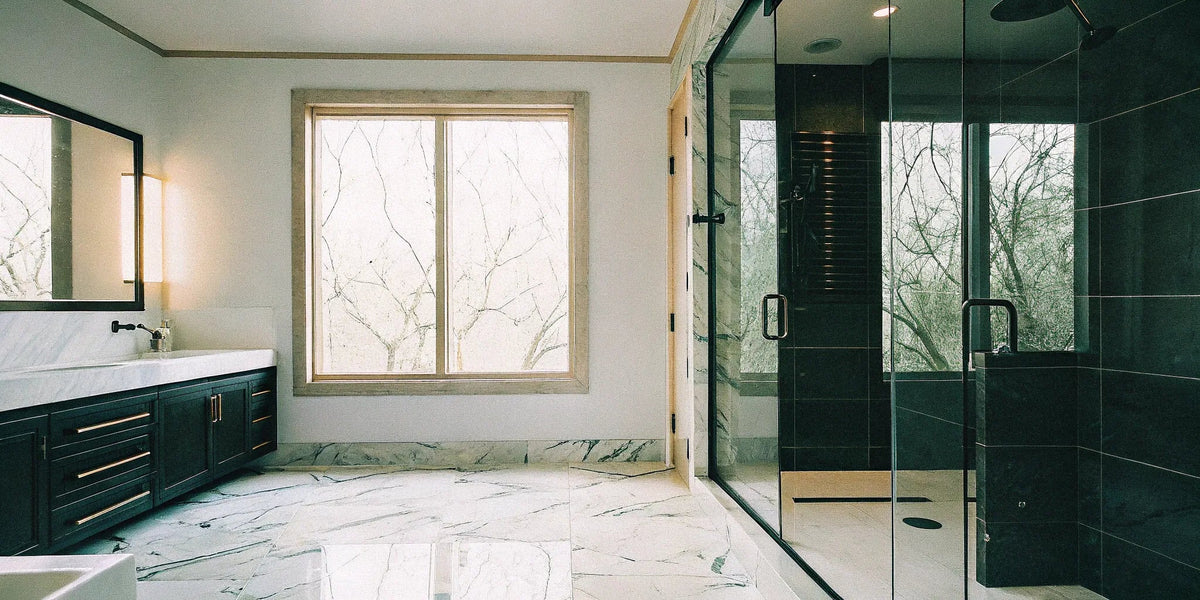 Large format porcelain slabs in a modern shower create a seamless design with minimal grout lines.