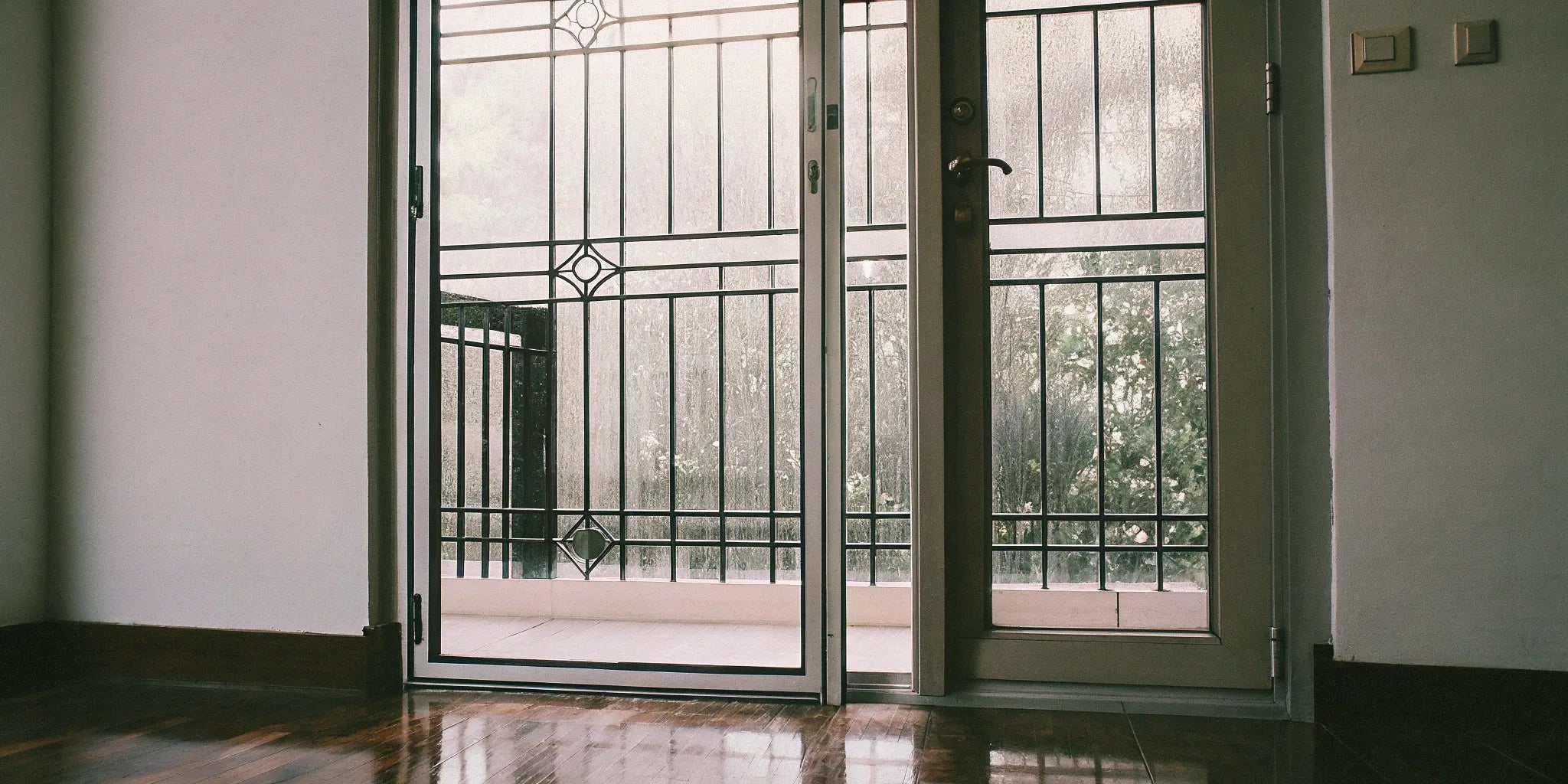 A modern black steel door with a full-view glass panel design.