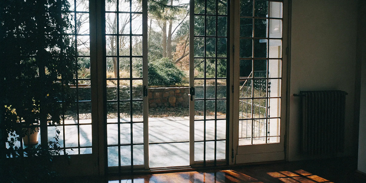 Sleek steel French doors enhance patio access.