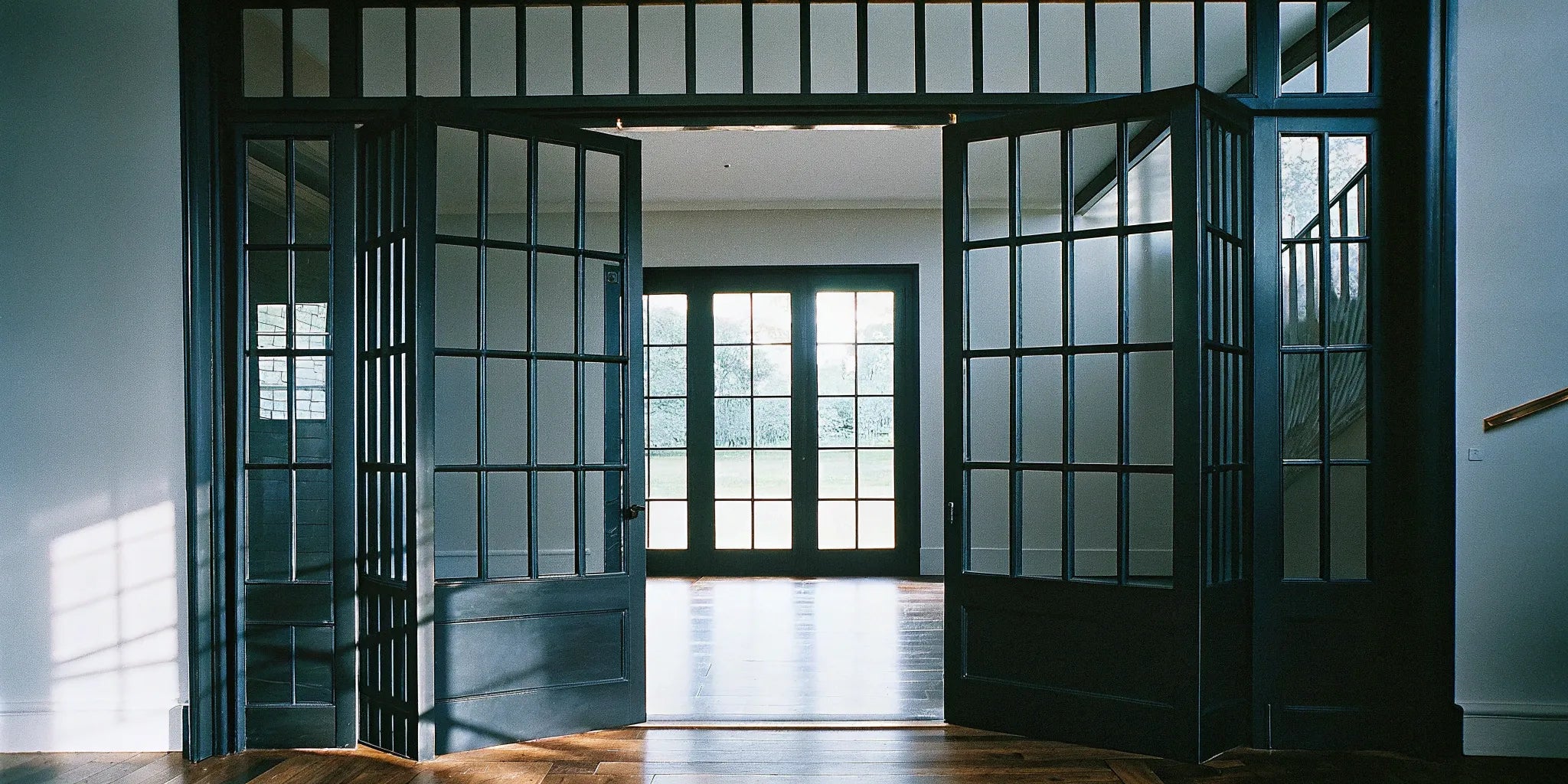 Black steel interior doors with glass panels for a modern, industrial home design.