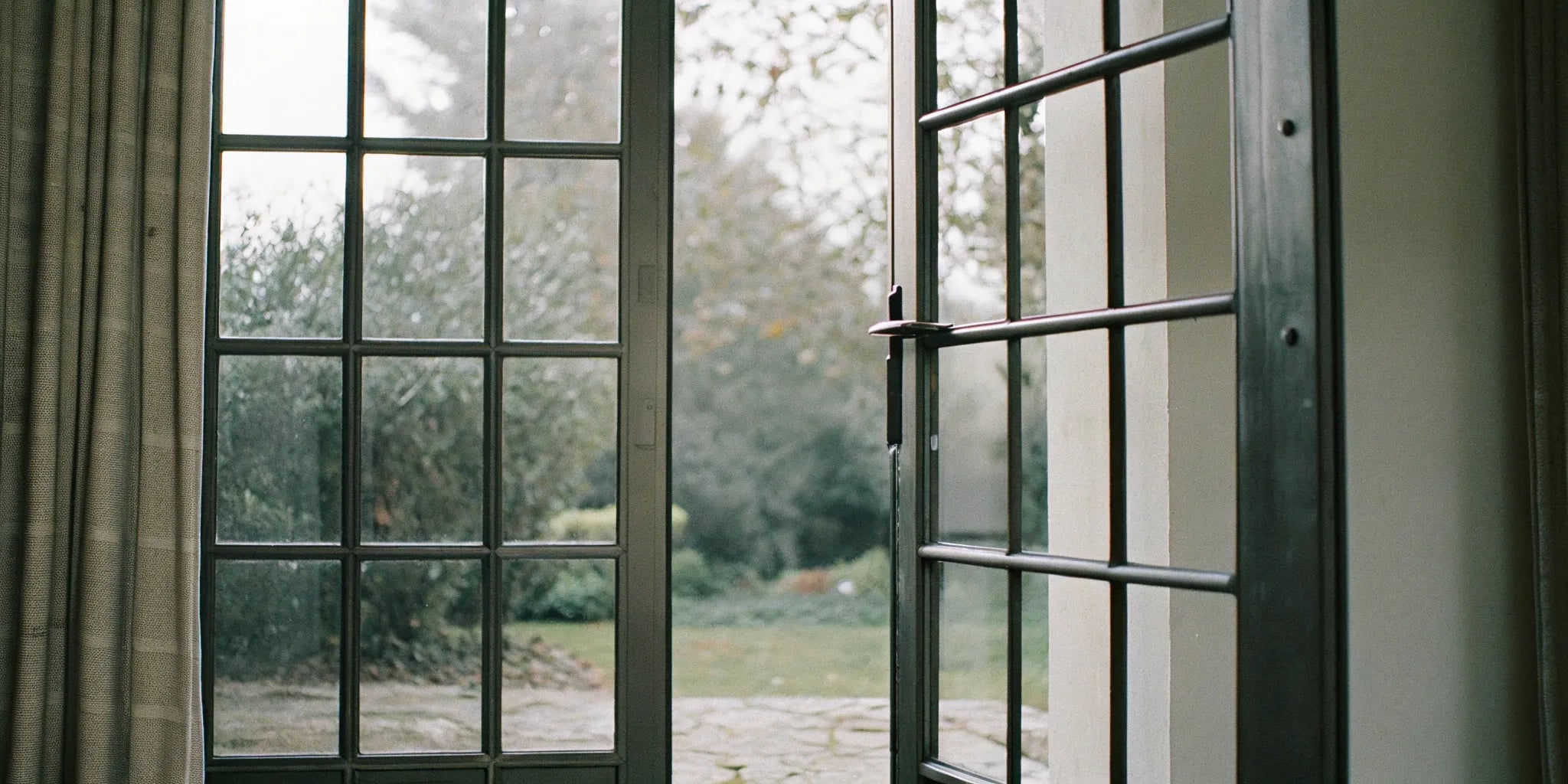 The price of black steel French doors is influenced by their modern design and glass panels.