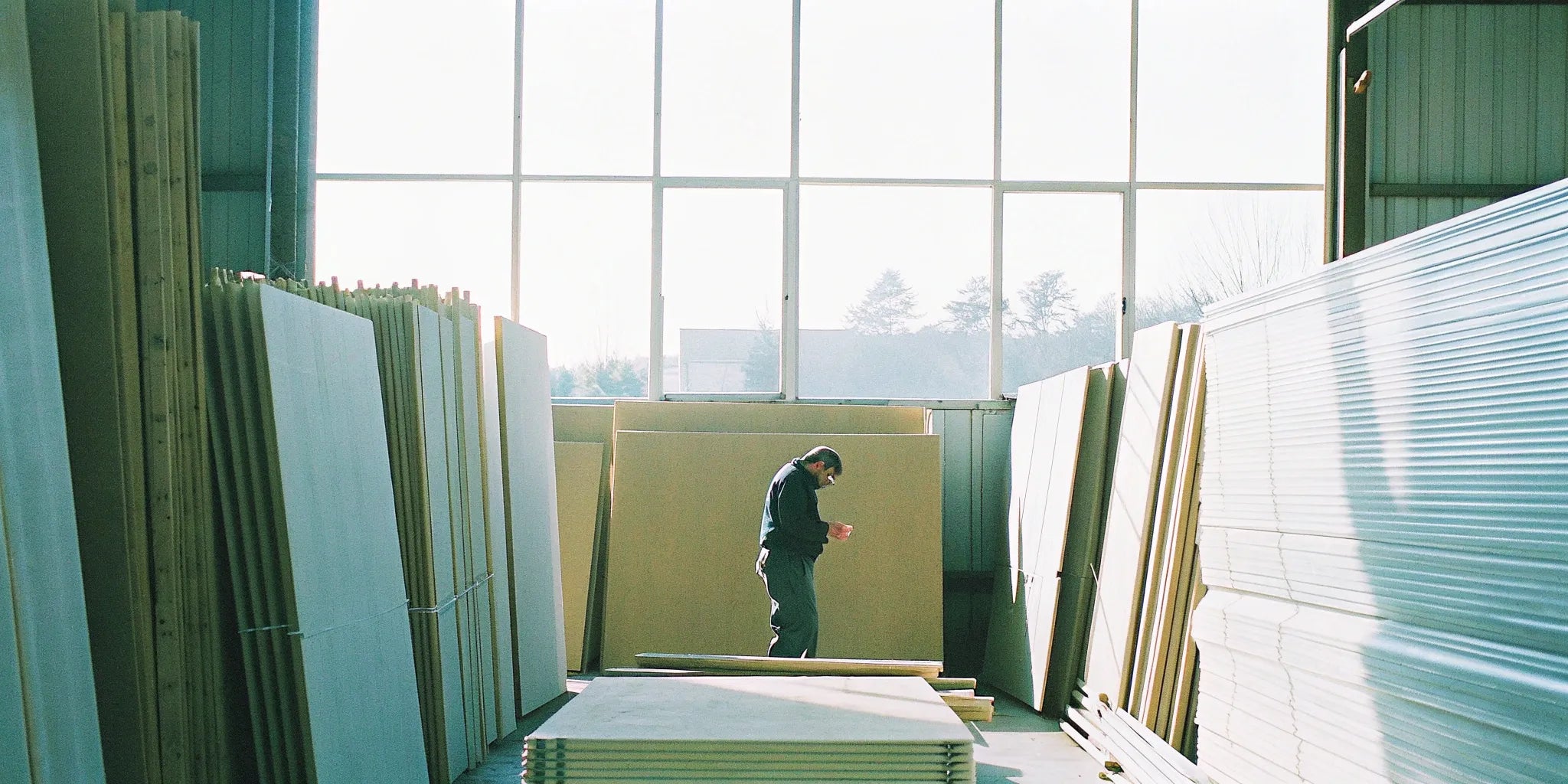 Stacks of wall panels in a warehouse for a builder's bulk order.