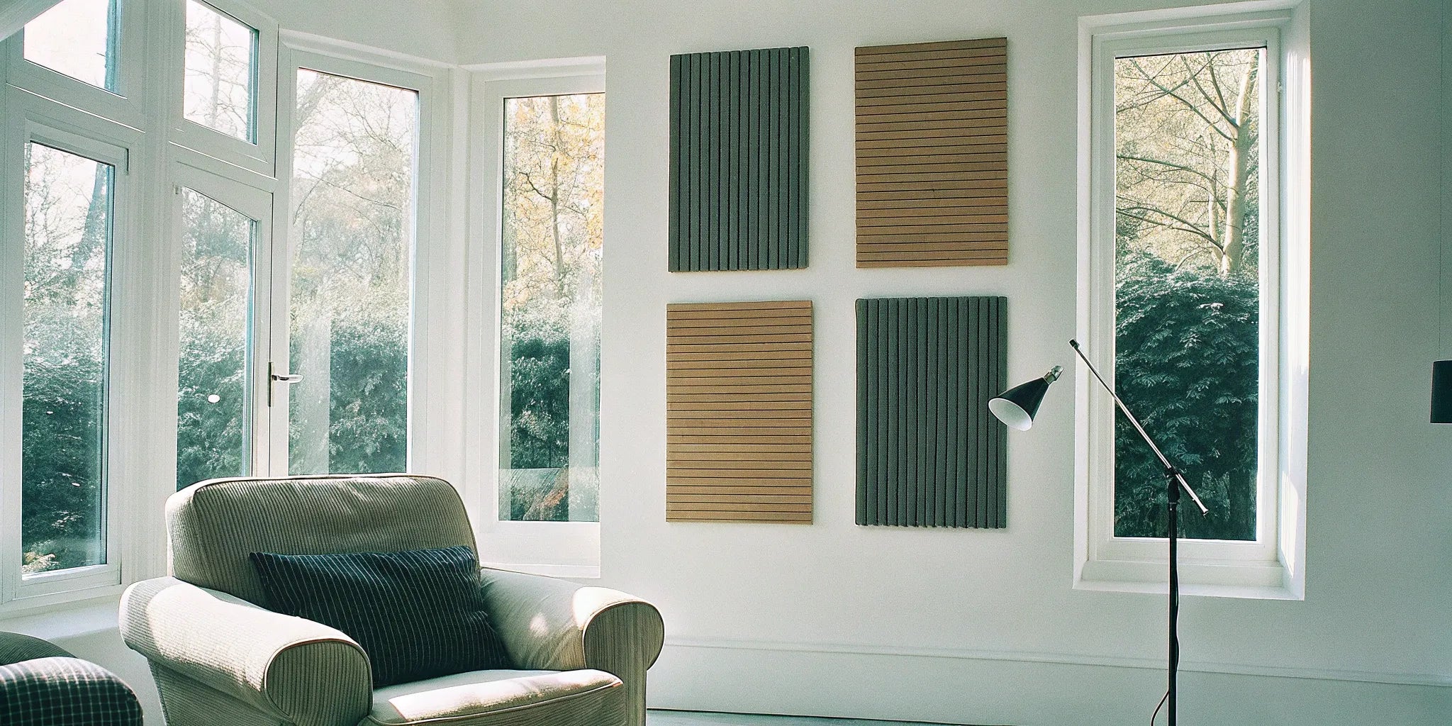 Acoustic wood slat panels on a feature wall in a modern living room.
