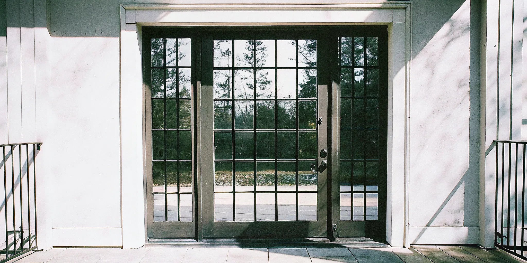A commercial steel exterior door with a large glass window for a business entrance.