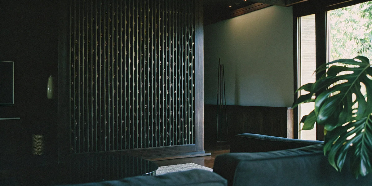 A decorative slat wall panel used as an accent wall in a modern living room.