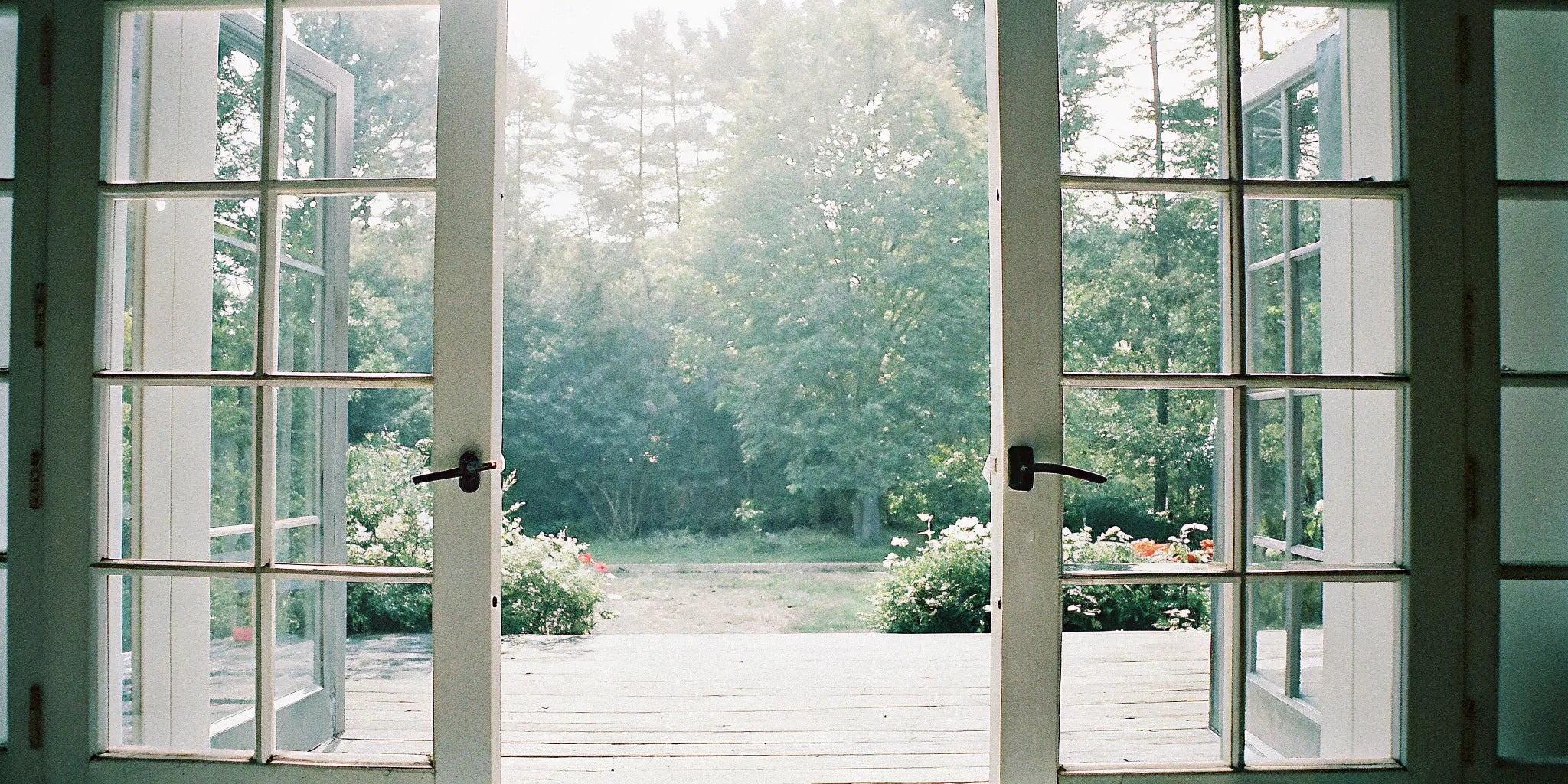 A set of 72x80 outswing exterior French doors opening onto a sunny patio.