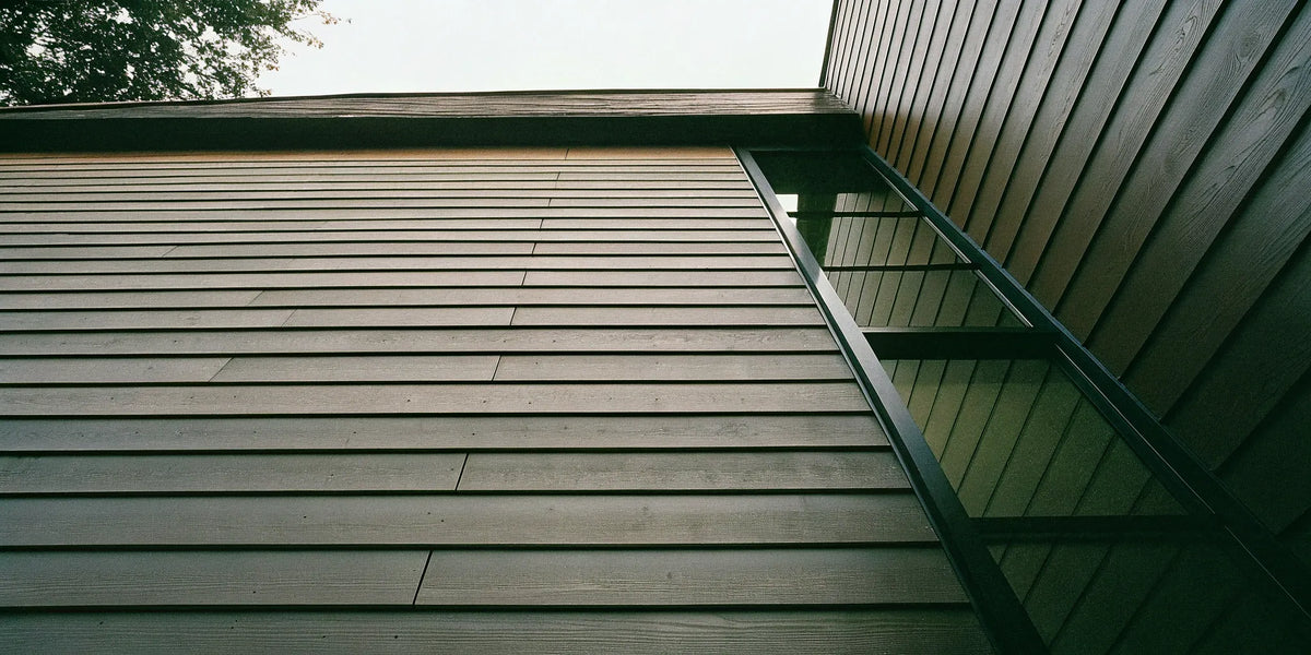 A modern building with sleek, horizontal fiber cement cladding panels.