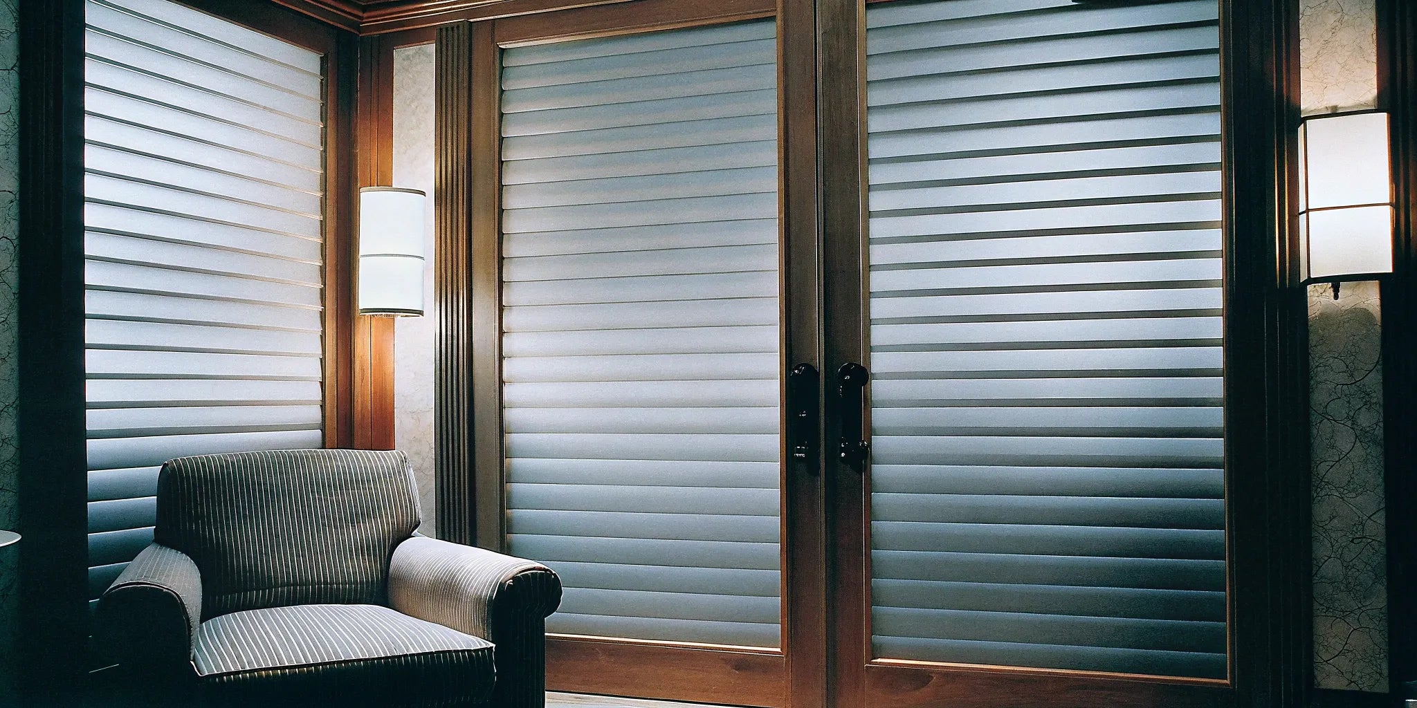 A modern living room accent wall with vertical fluted tambour panels in a natural wood finish.