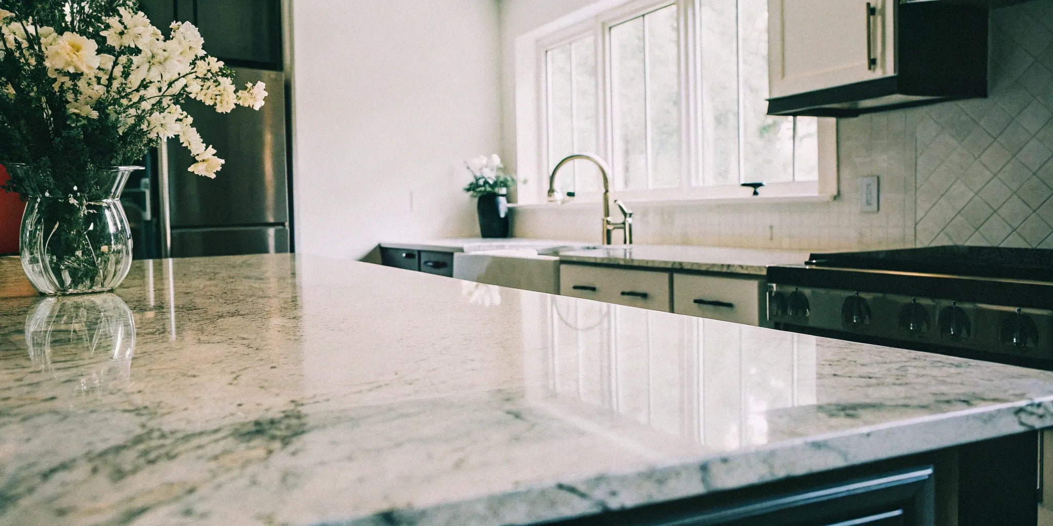 A modern kitchen featuring countertops made of large format porcelain slabs.