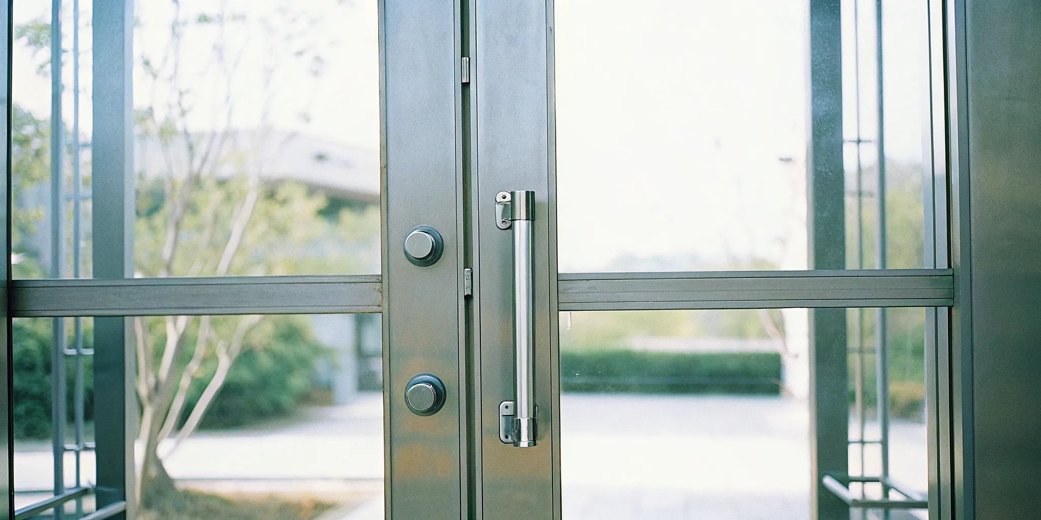 Modern steel entry doors with glass panels and sleek hardware.