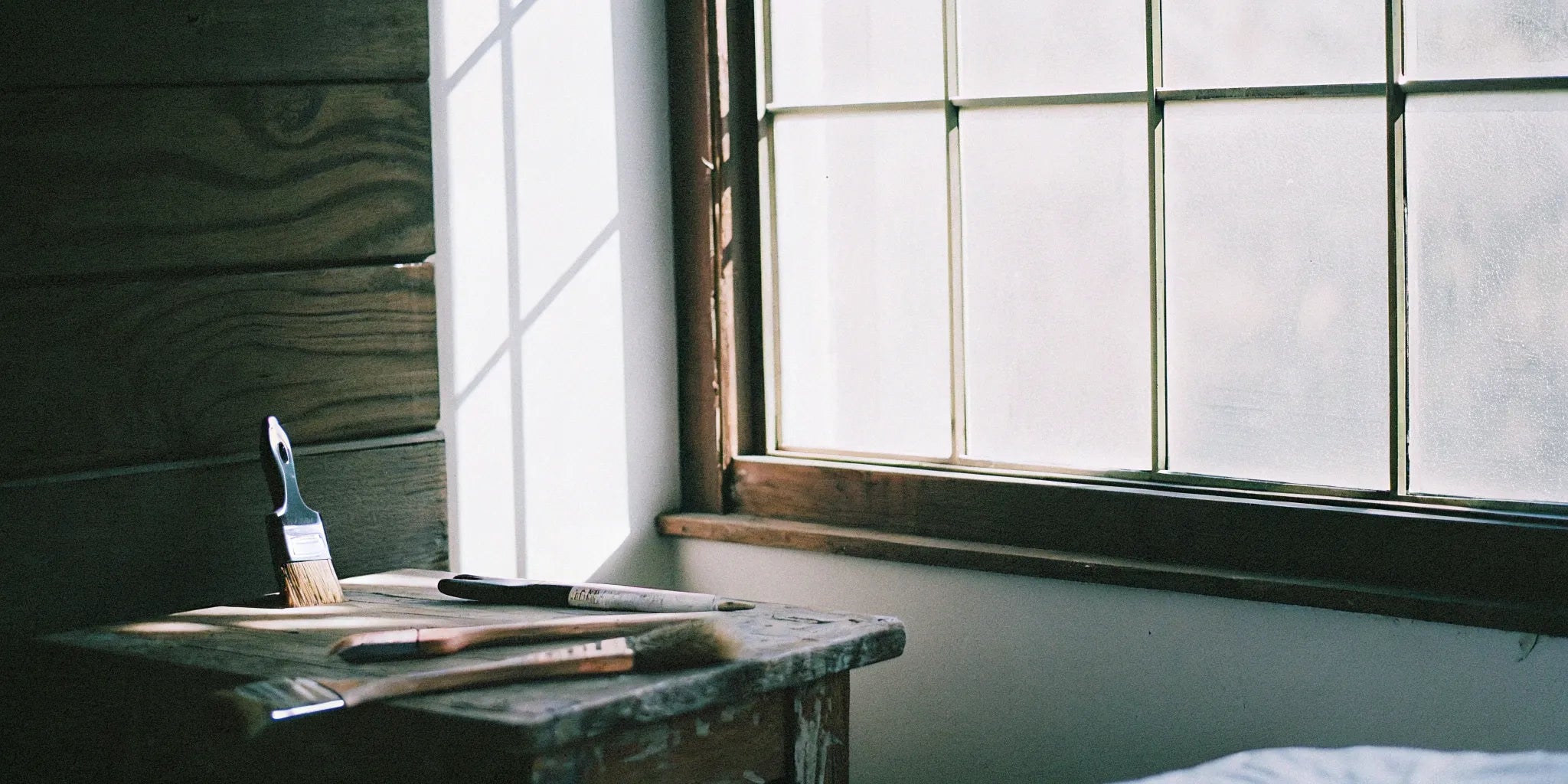 A freshly installed wall of paintable wood paneling ready to be painted.