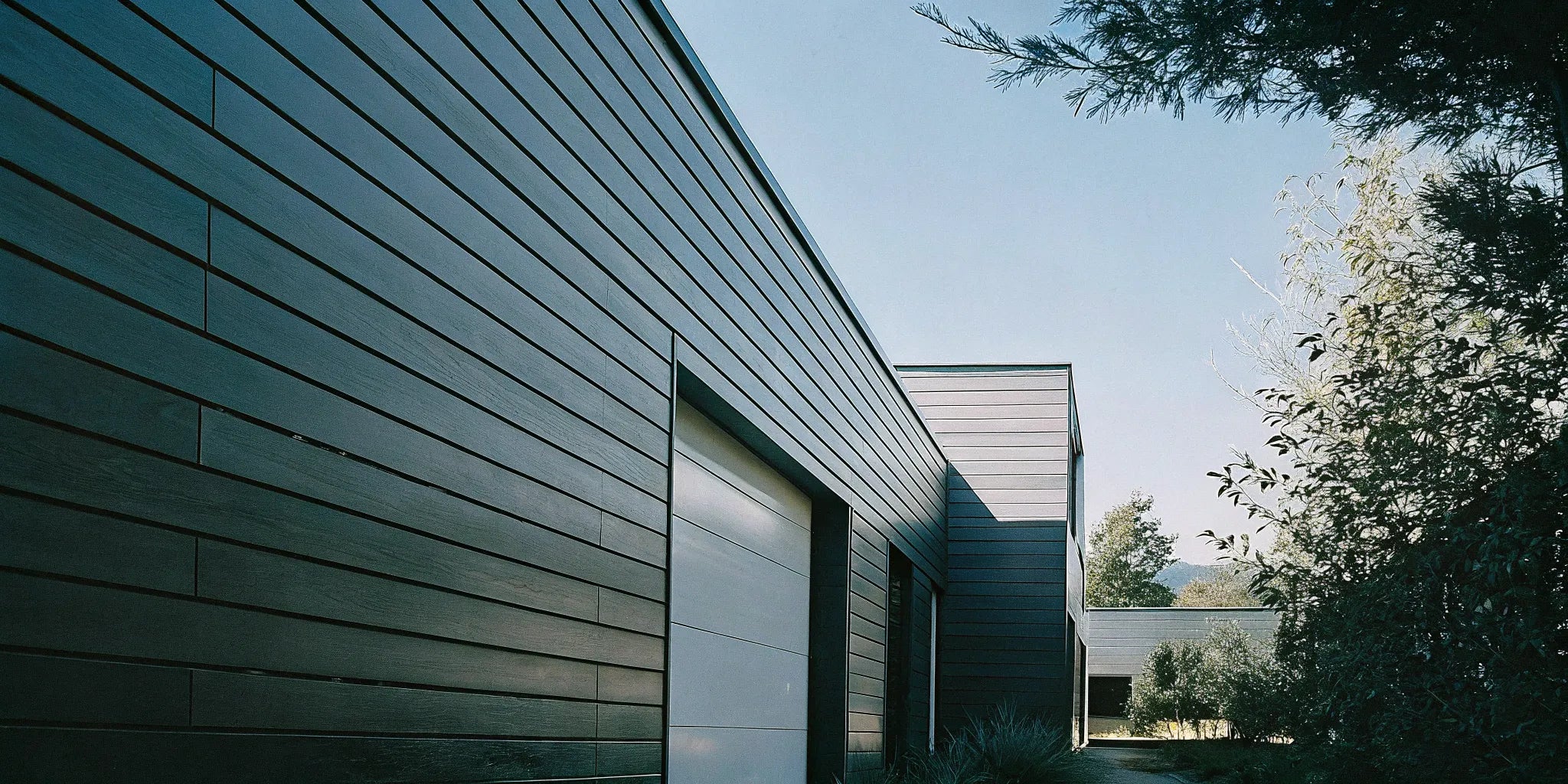 Modern home exterior featuring dark WPC cladding for a sleek and durable facade.