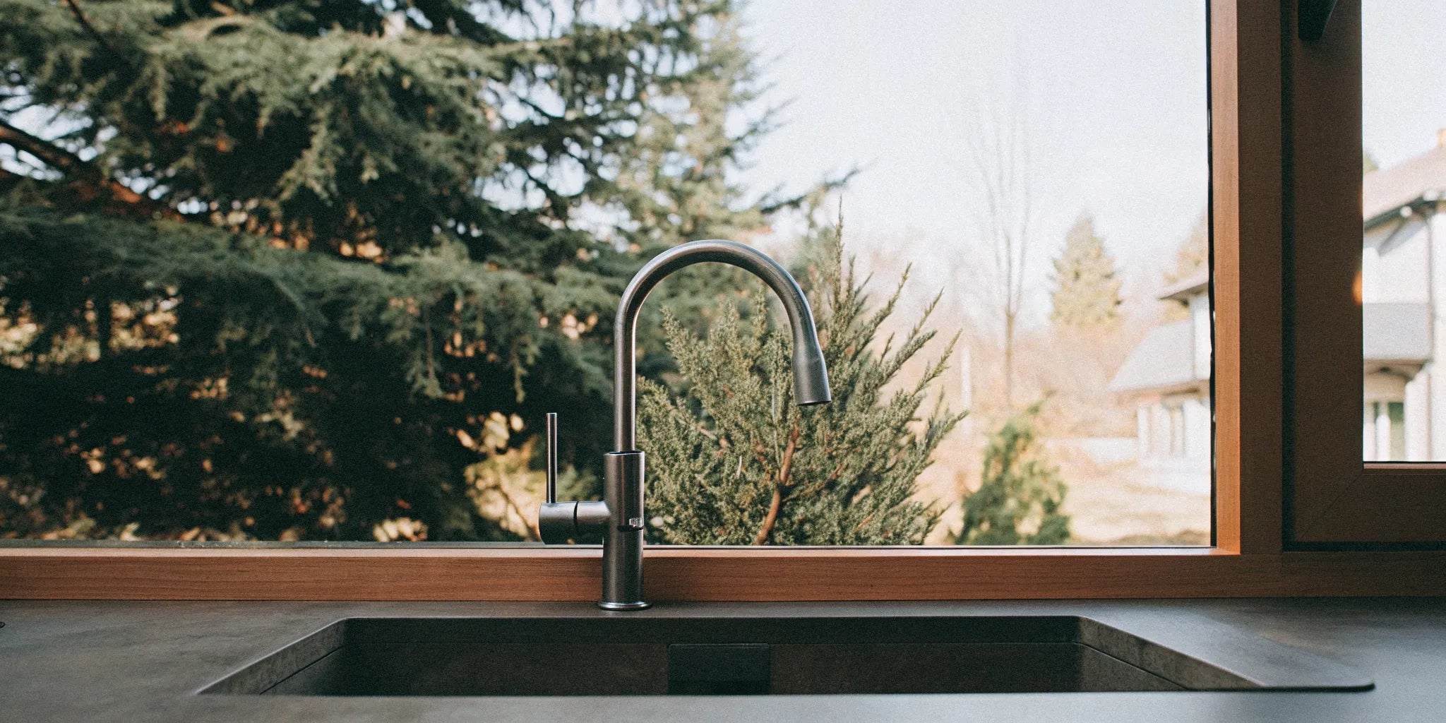 A modern kitchen faucet in a sunlit kitchen, a guide on what to know before you buy online.