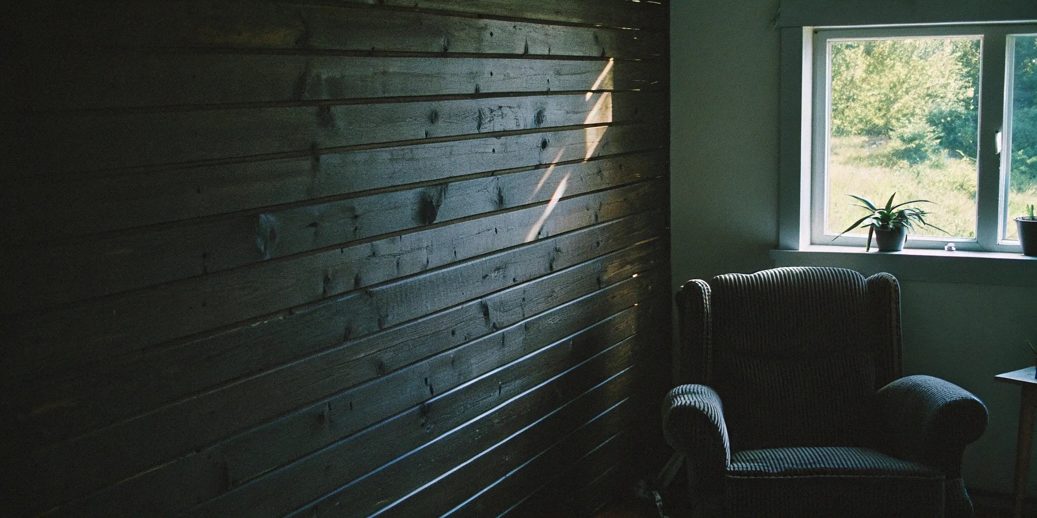 A DIY wood slat wall with evenly spaced vertical wood panels.
