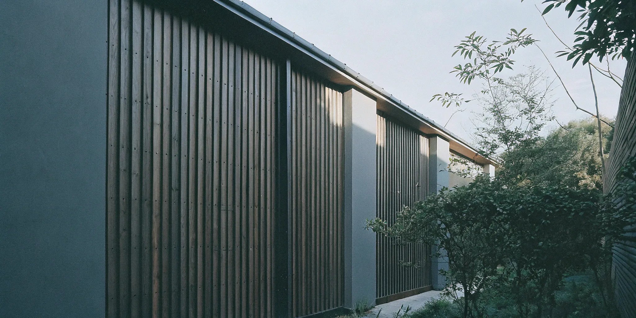 Modern home exterior with vertical WPC fluted panel siding.