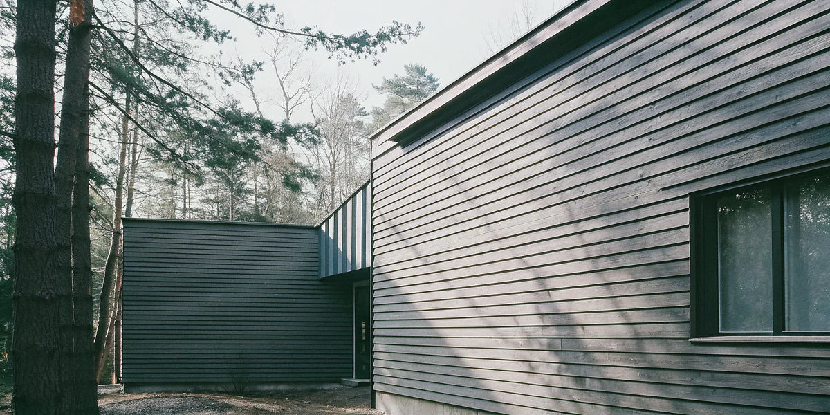 Dark vertical shiplap exterior siding on a modern home.