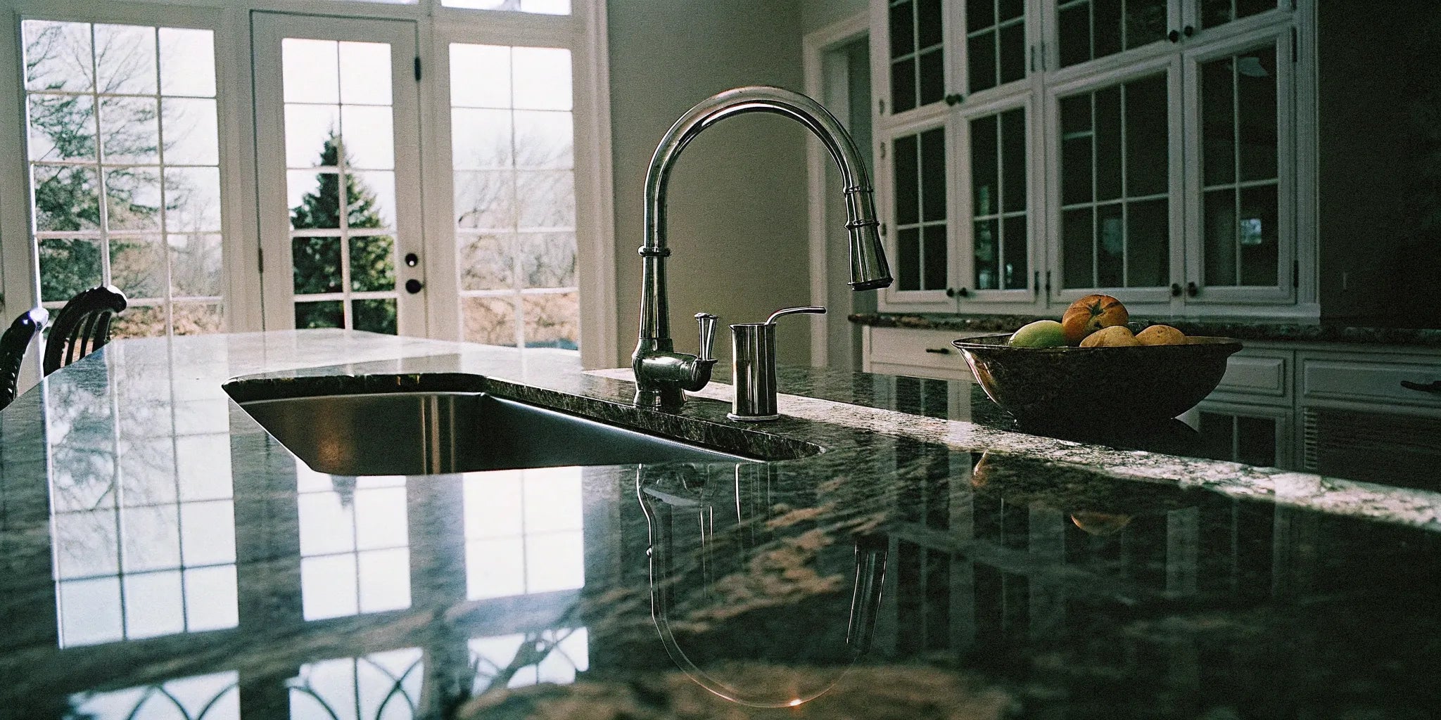 A sleek, modern faucet installed over a clean kitchen sink.