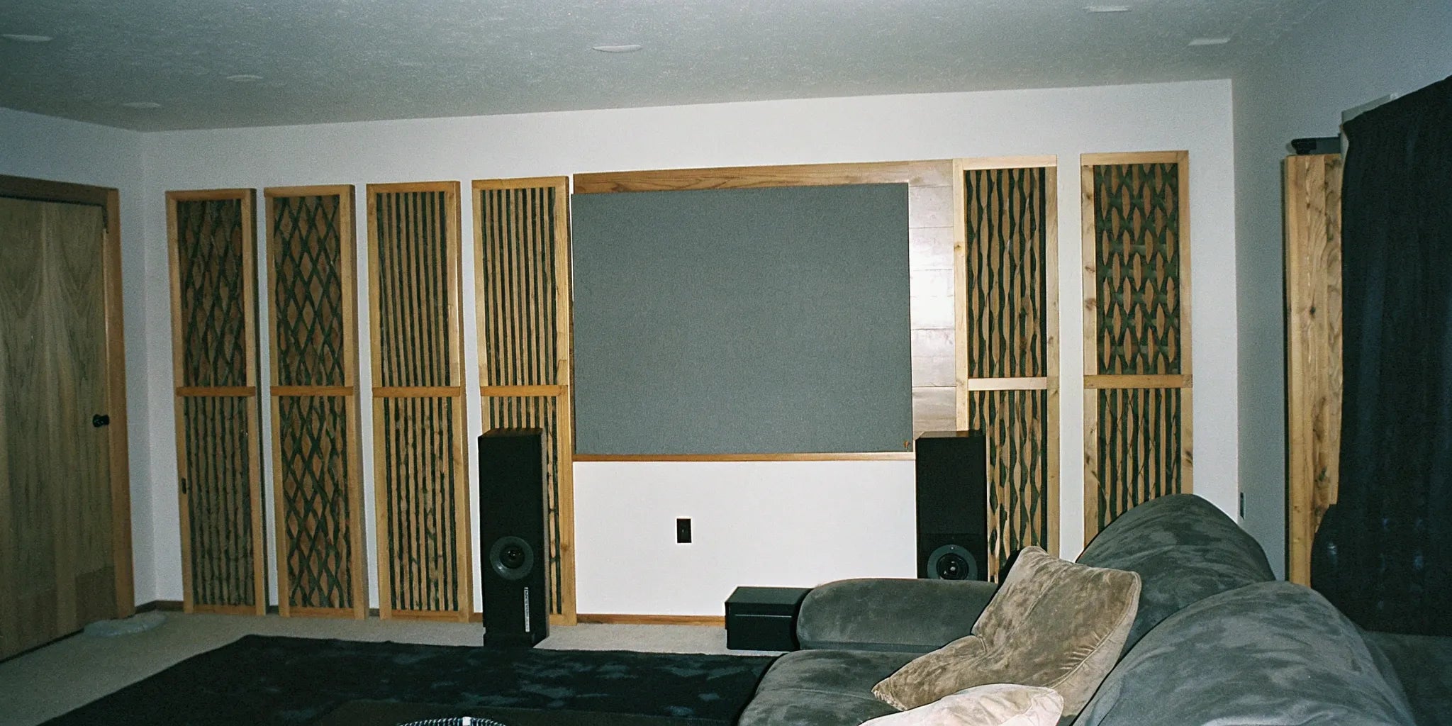 A living room featuring decorative acoustic wood panels on an accent wall.