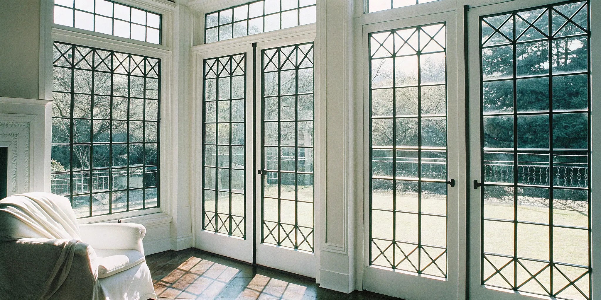 A steel French window with a modern grid design and slim, durable frames.