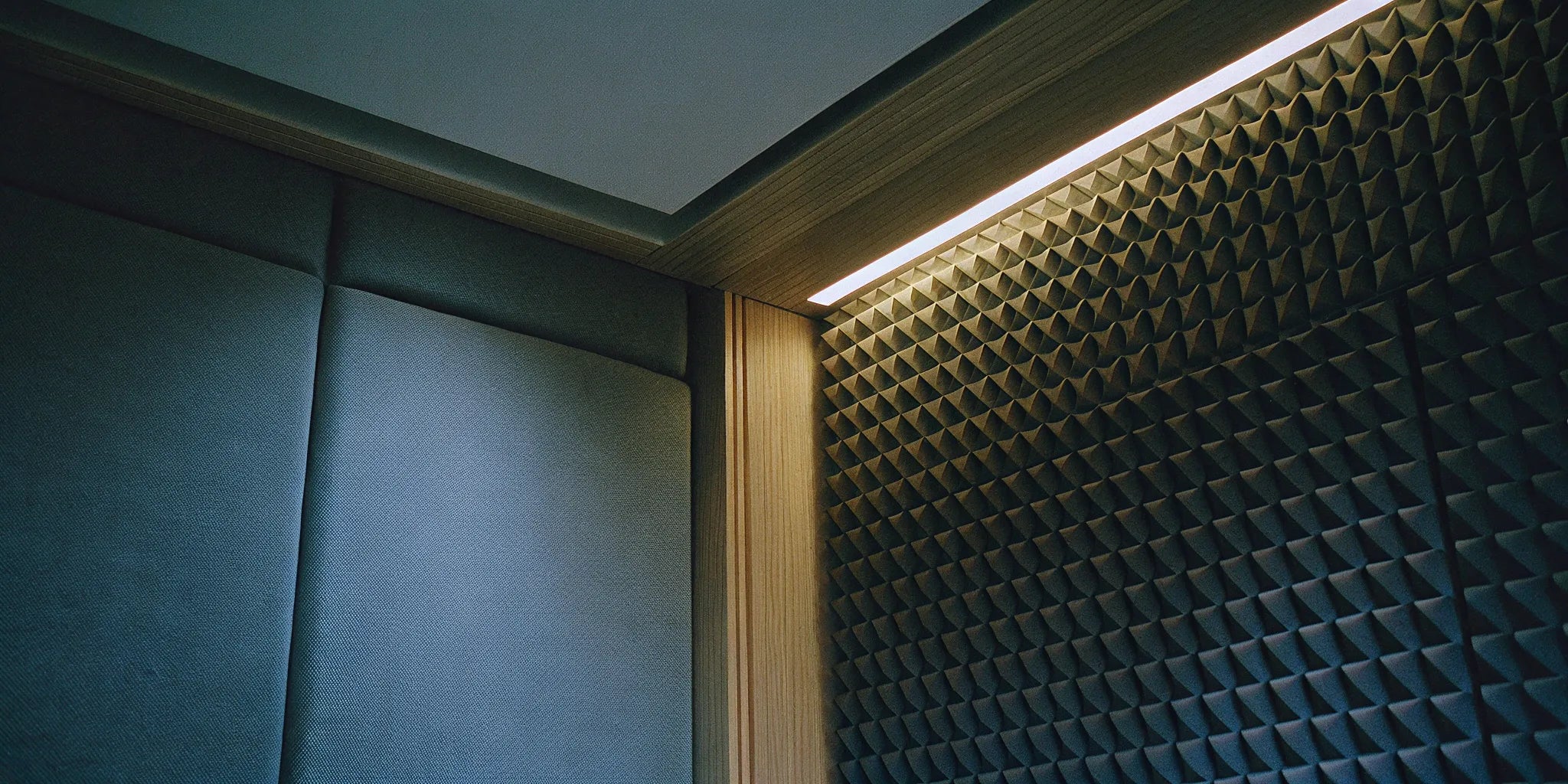 Acoustic panels vs. soundproofing on a wall, comparing sound absorption and sound blocking.