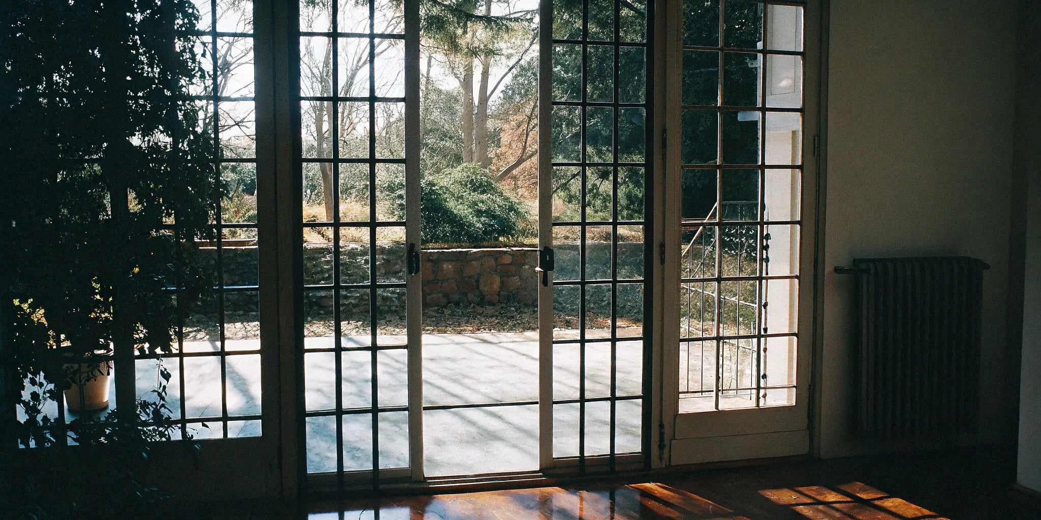 Sleek steel French doors enhance patio access.
