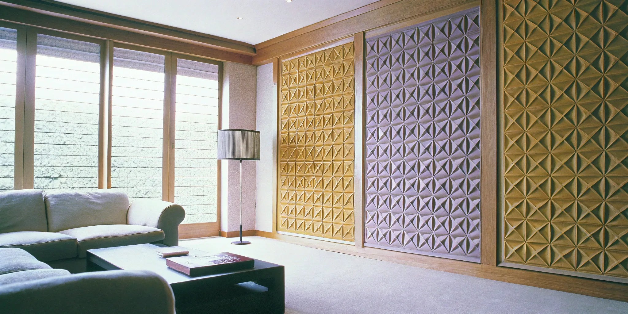 3D wall panels add depth and texture to a living room.