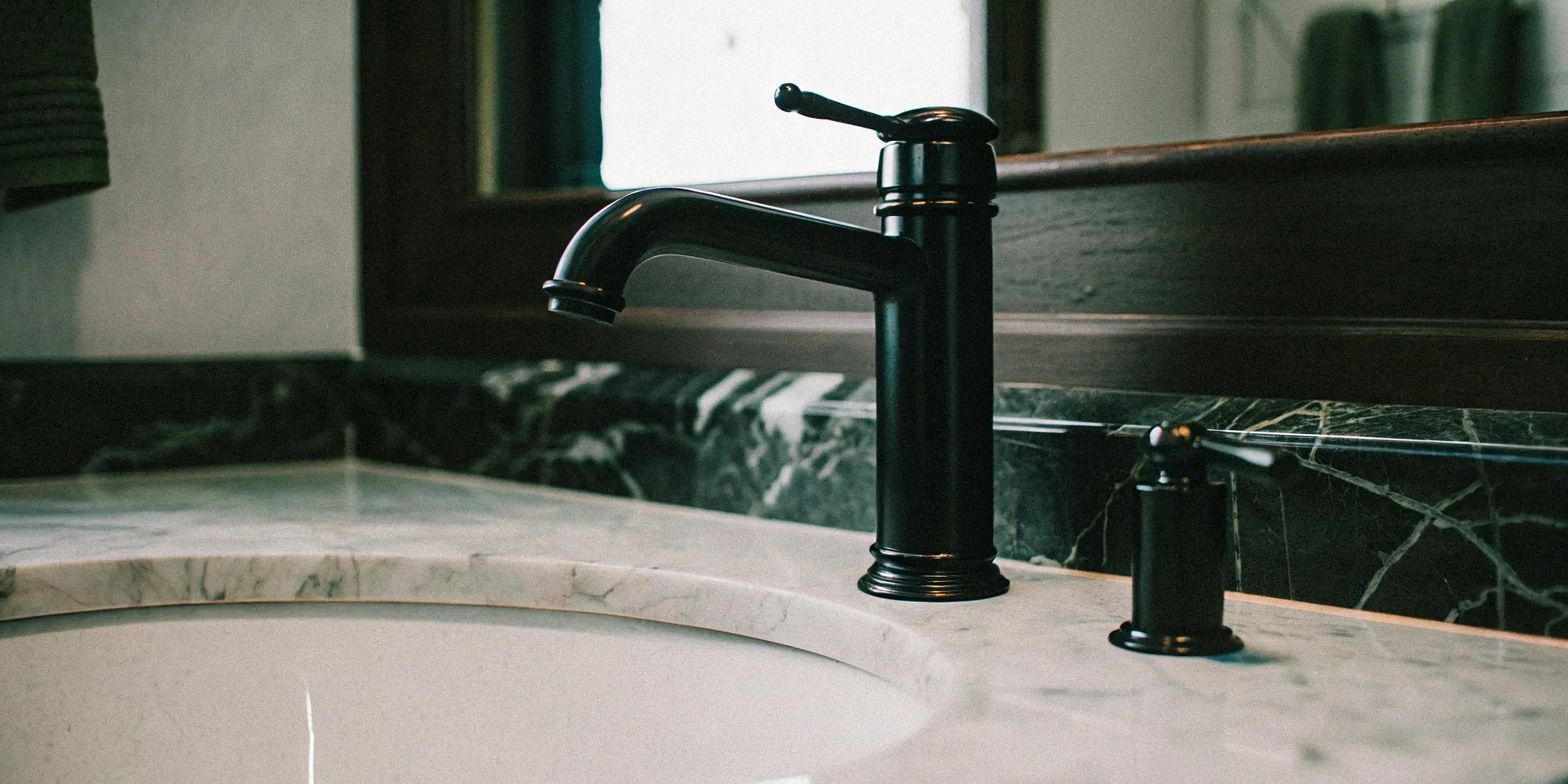Sleek black faucet in a modern bathroom.