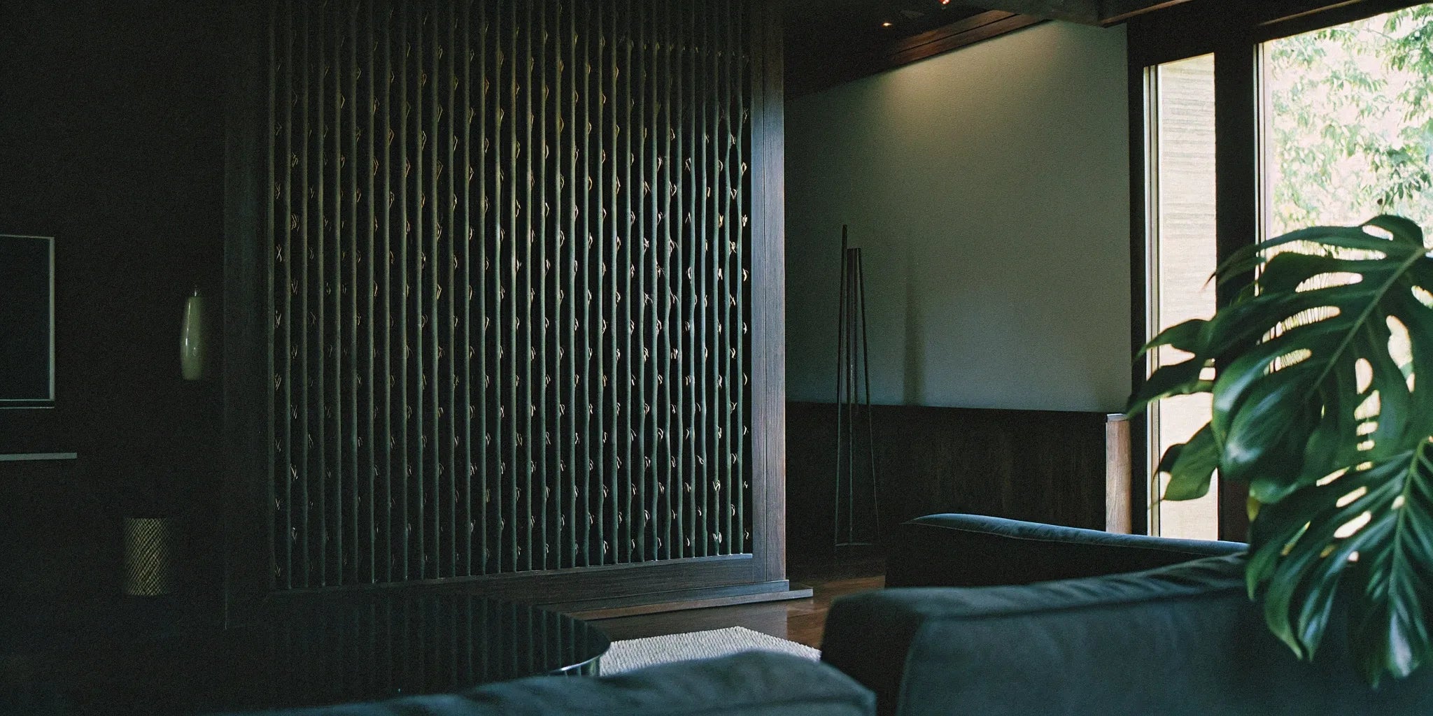 A decorative slat wall panel used as an accent wall in a modern living room.