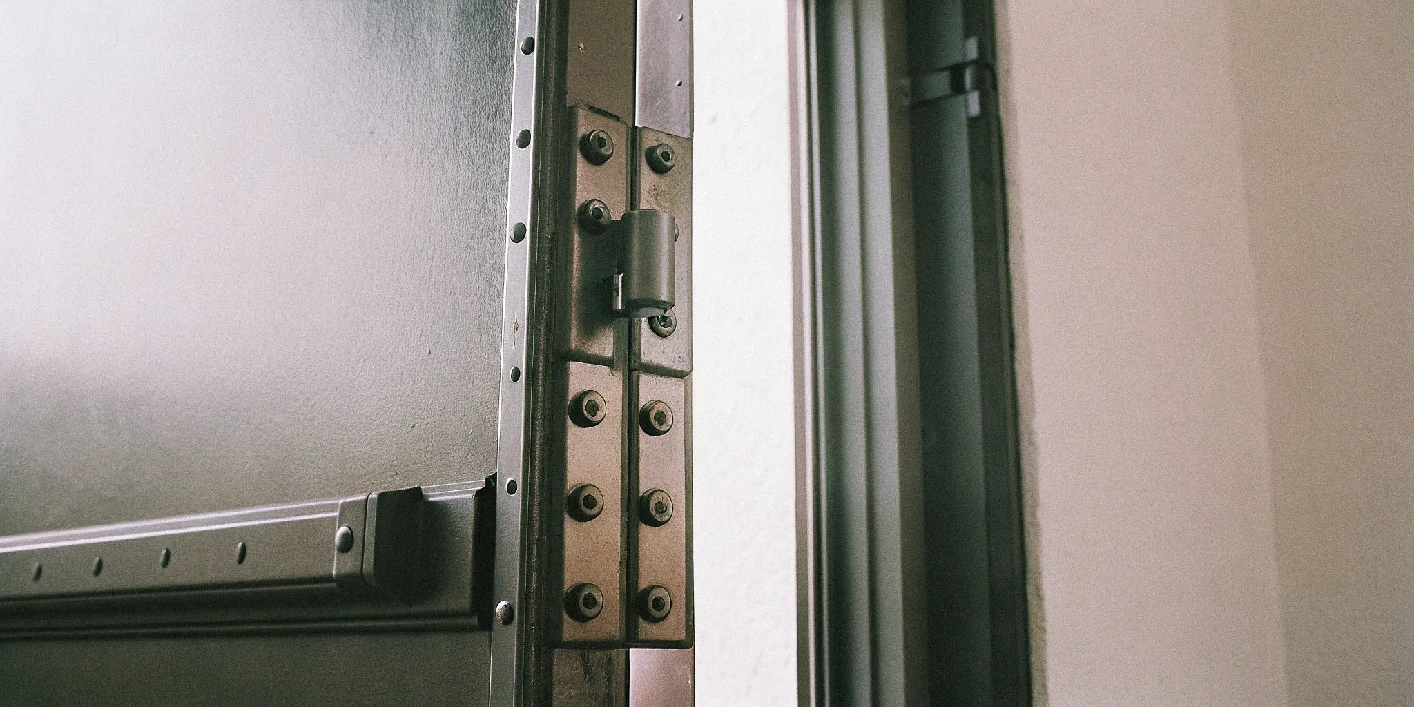 Fire-rated steel door with reinforced frame and hardware.