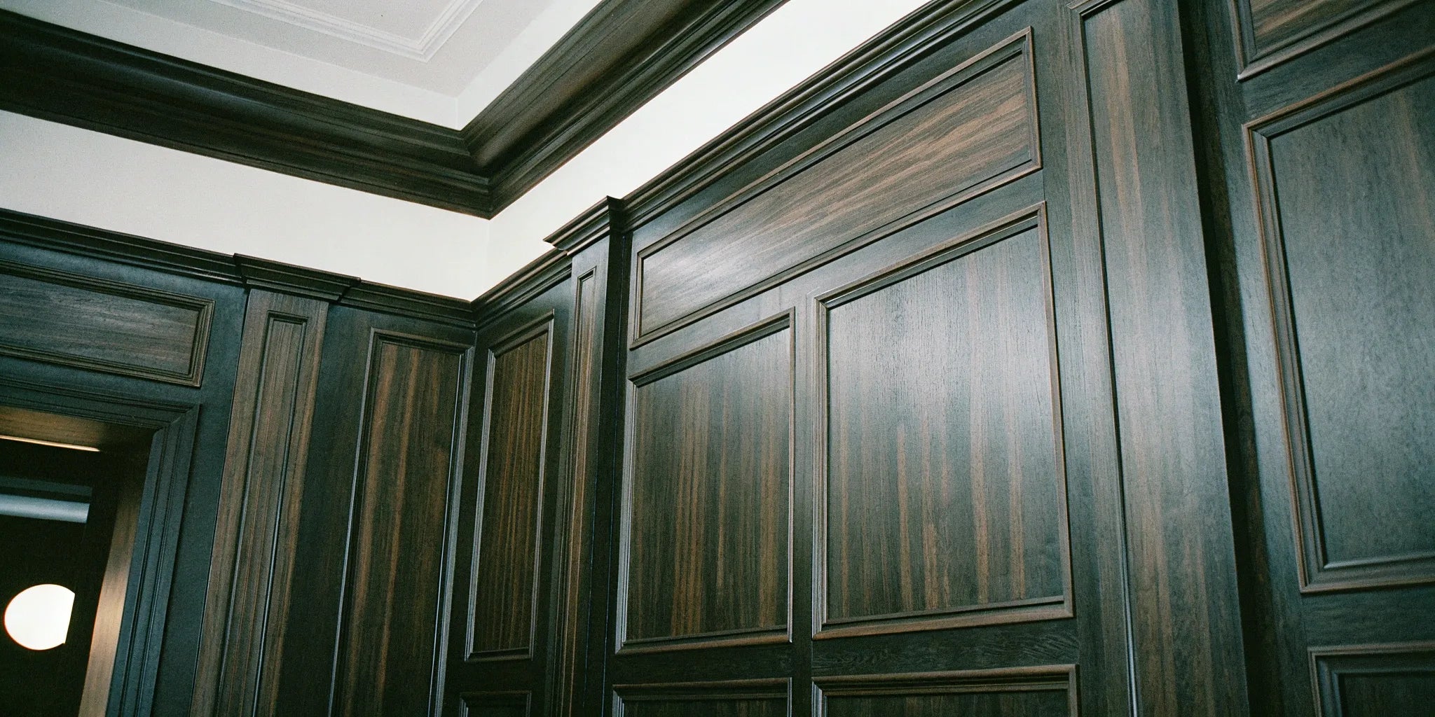 Dark fluted wood wall panels add depth and texture.