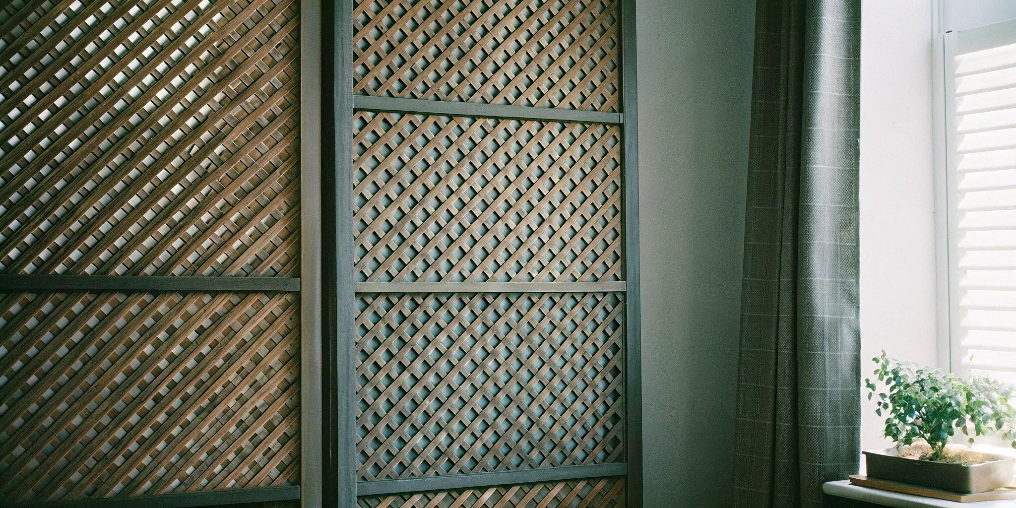 Decorative 4x8 slat wood panels installed on a modern living room accent wall.