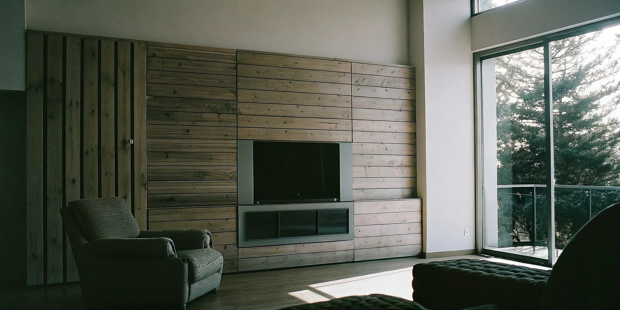 A modern living room with an accent wall of lightweight wood panels.