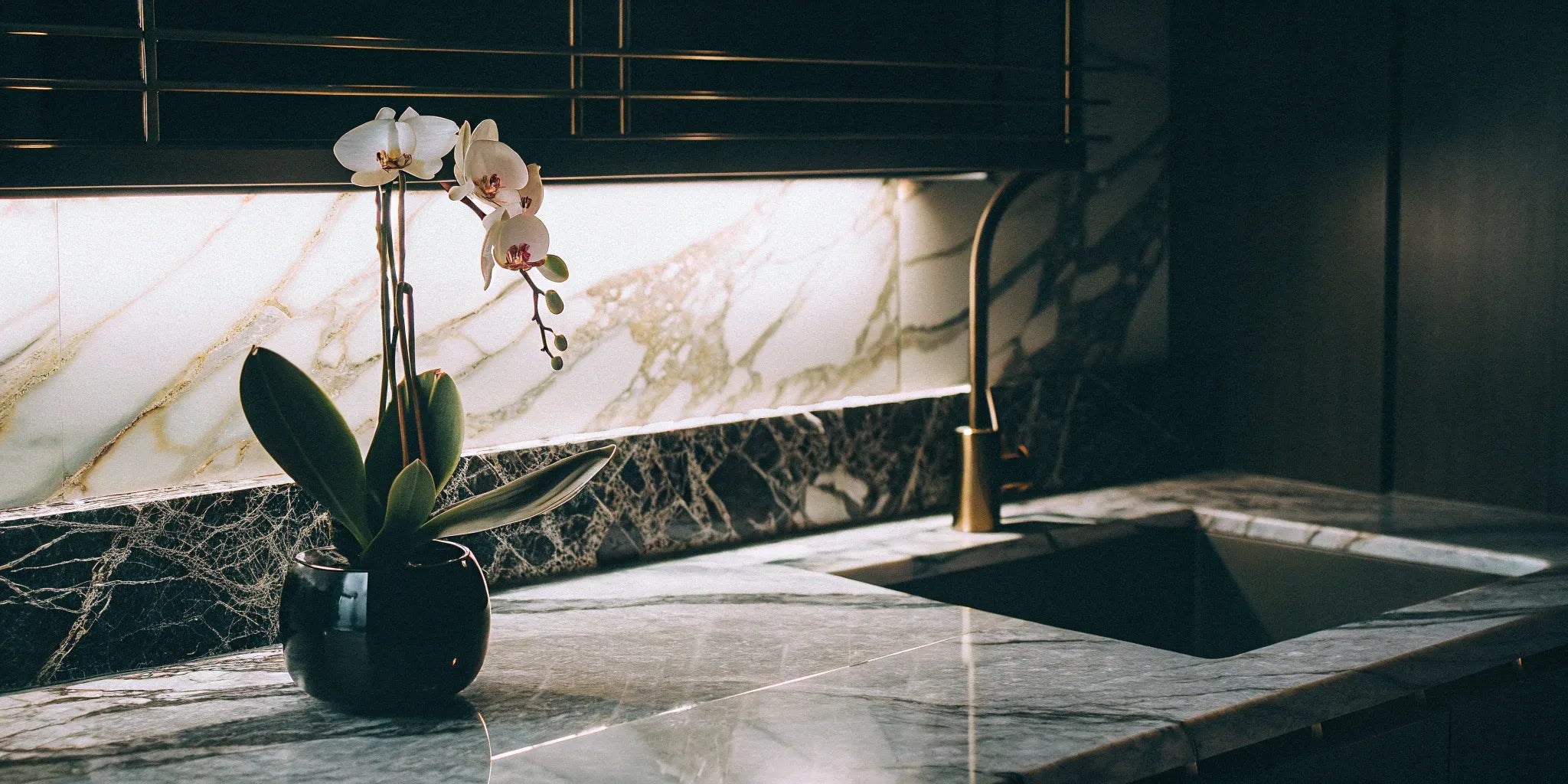 Marble-look Maximo porcelain slabs installed as countertops and backsplash in a modern kitchen.