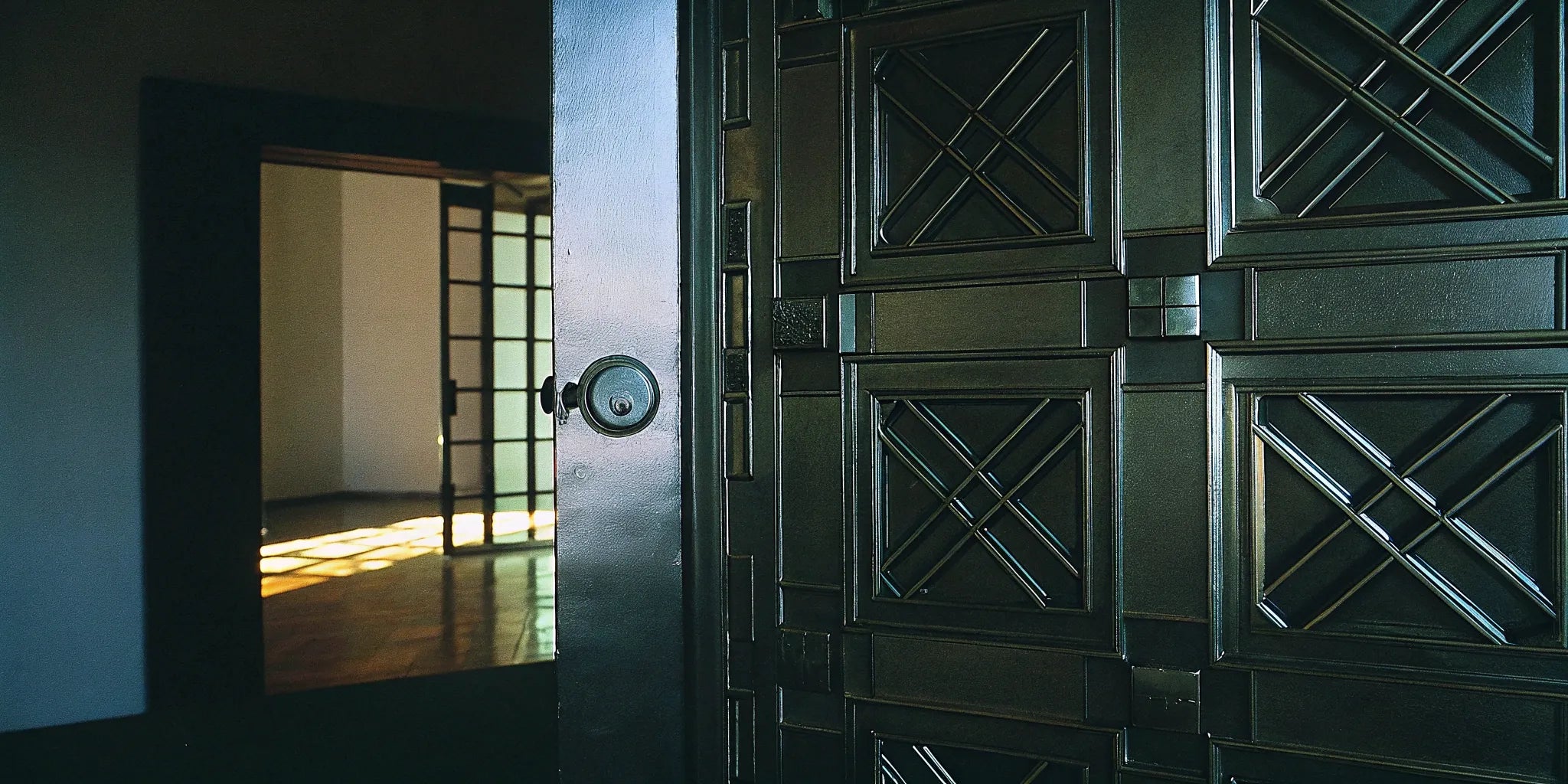 Secure steel door with geometric panel design.