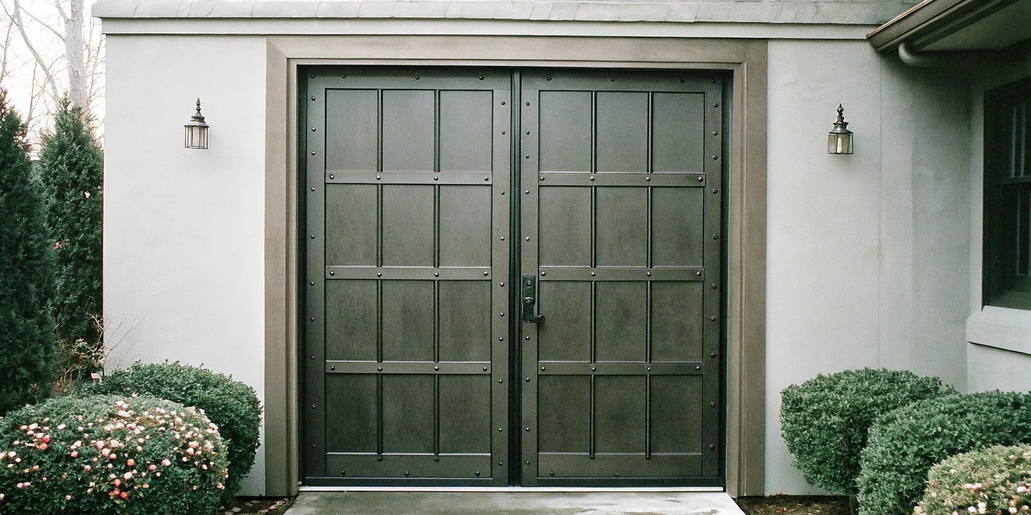 Classic double steel front doors with secure hardware for a residential home.