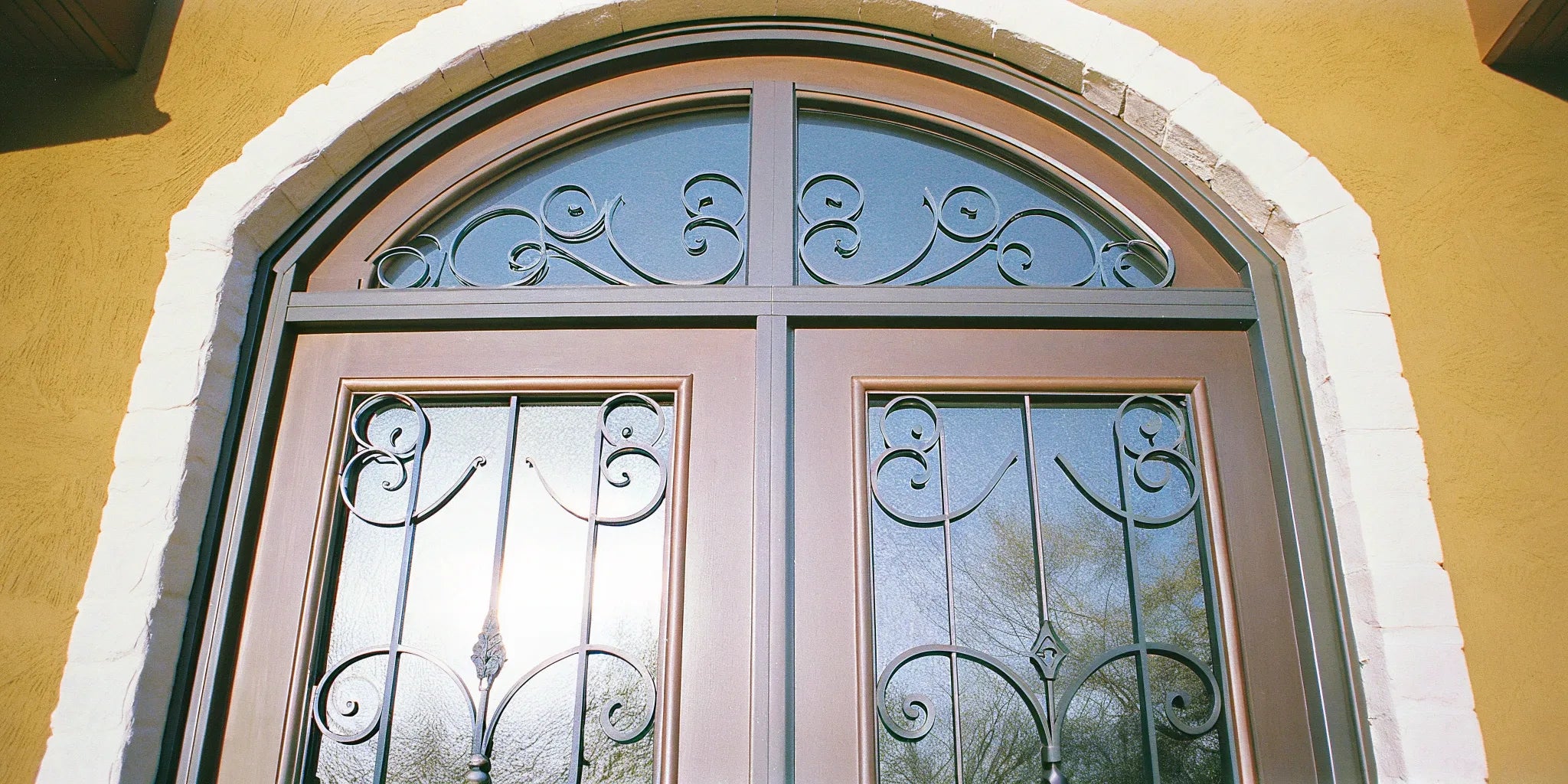 A set of custom steel doors with decorative glass and ironwork, found at a supplier near me.