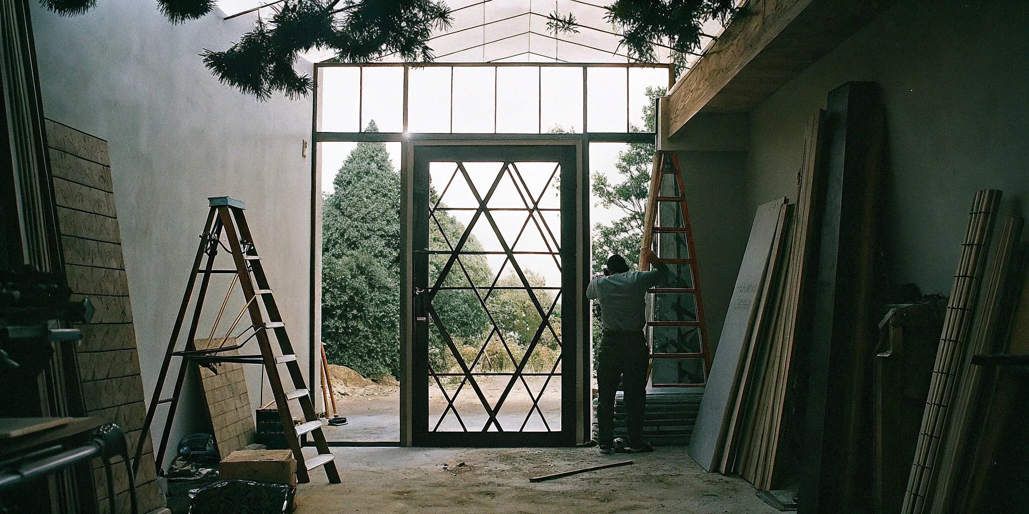 Installation of custom steel doors and windows in a modern building with large glass panels.