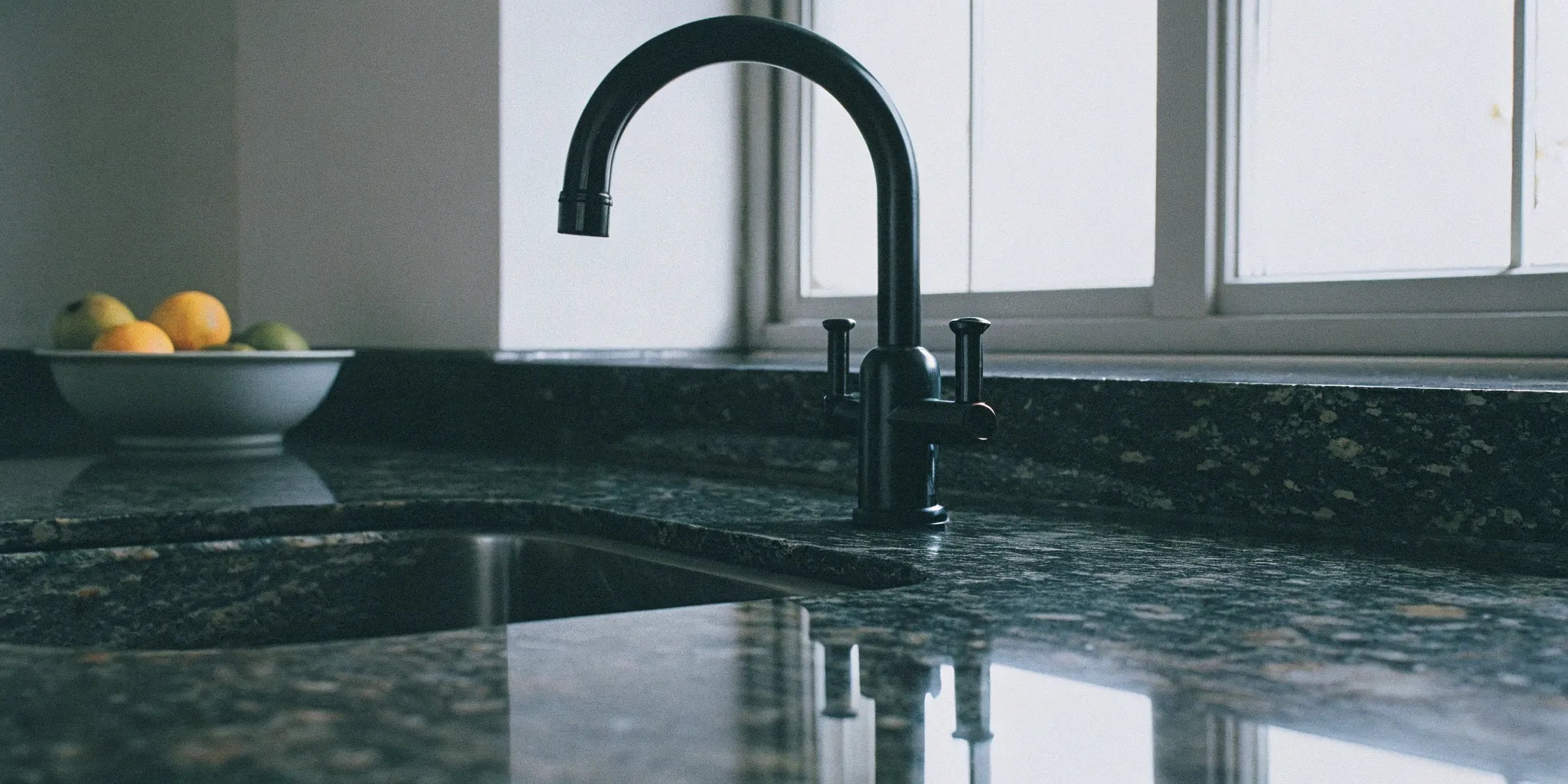 Sleek, matte black kitchen faucet.