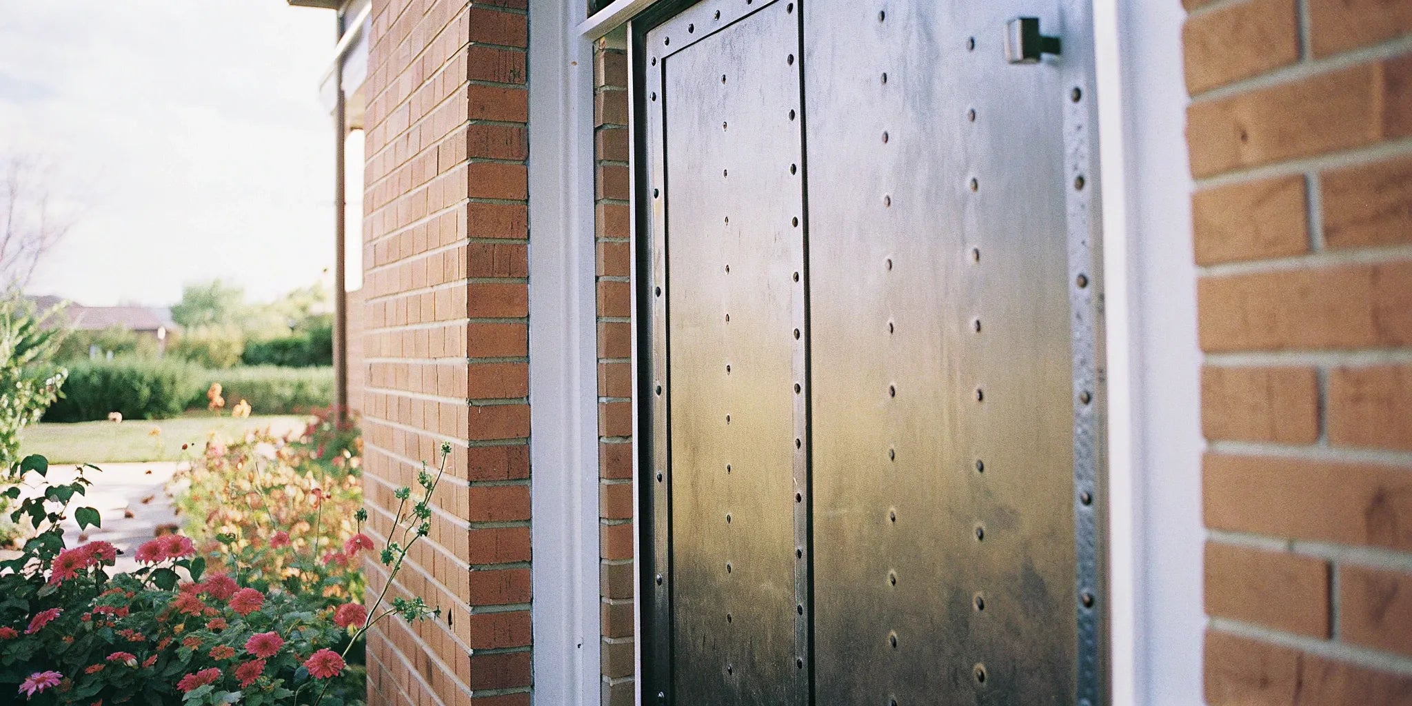 A secure metal exterior door for sale on a commercial building entrance.