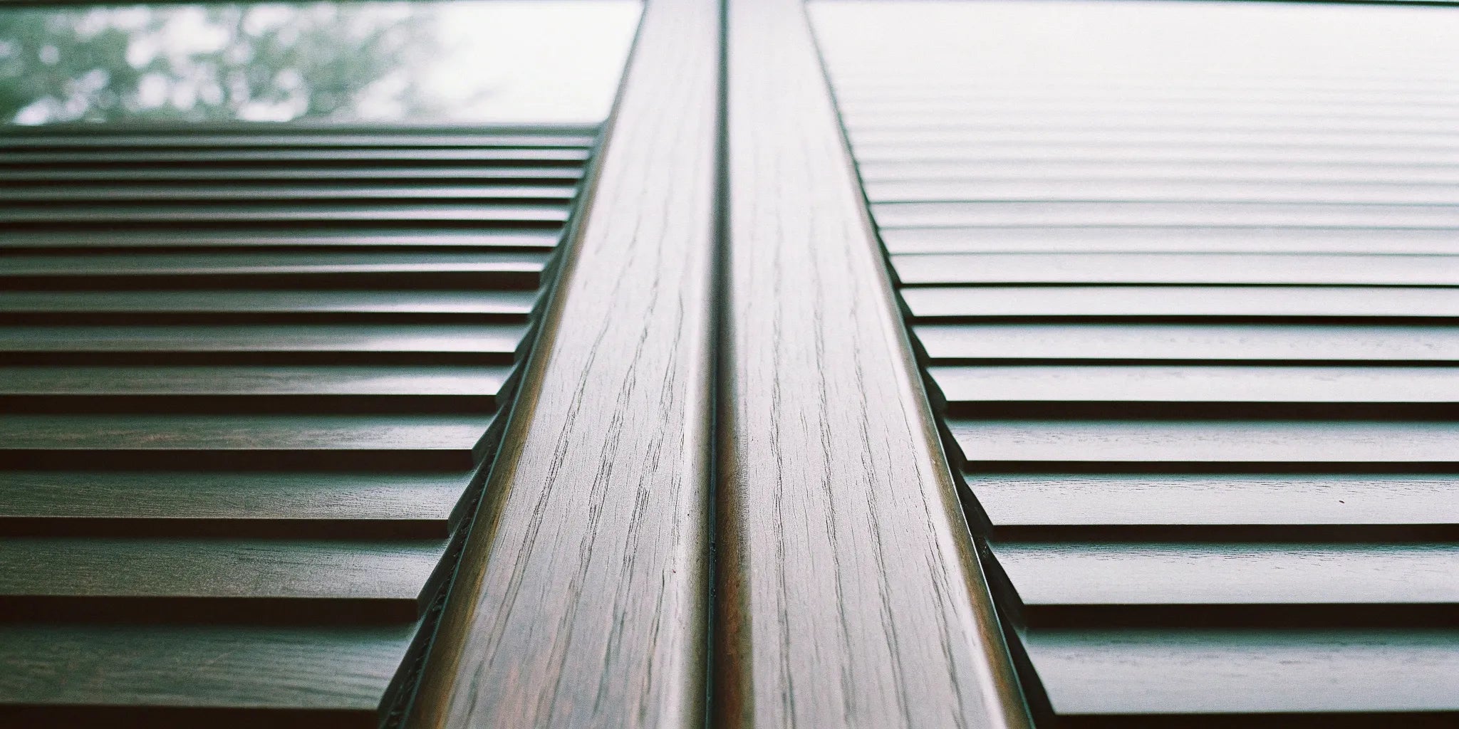 Solid wood tambour panels with a slatted design and detailed natural wood grain.